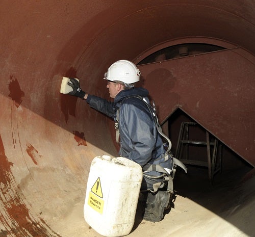 A person using chemicals in a confined space 