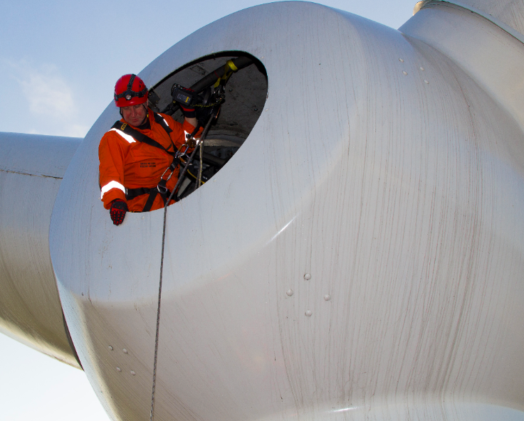 A person on the inside the nacelle of a wind turbine