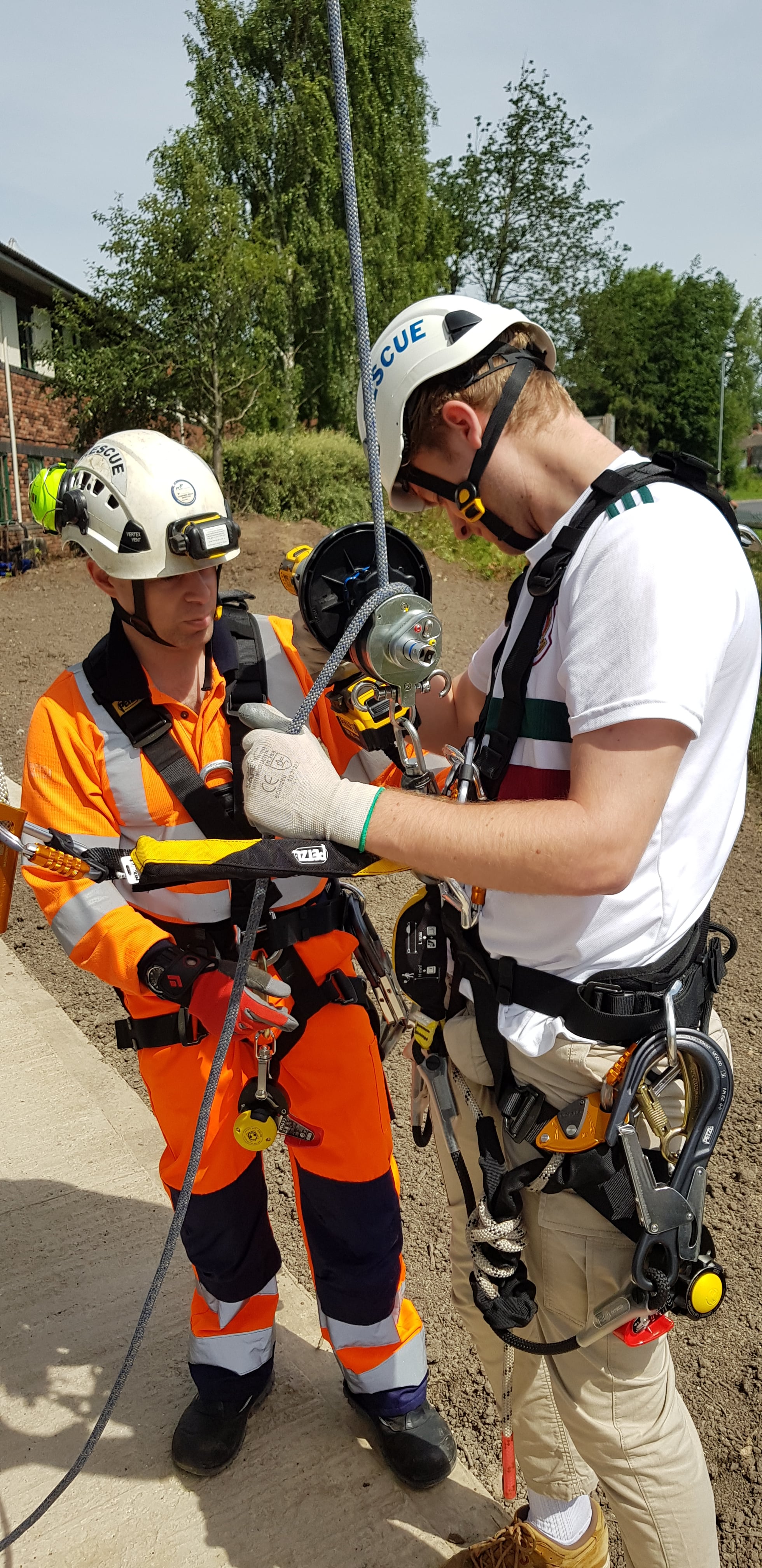 Equipment being worn and checked on a practical work at height training course. 