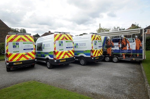 Three MRS Training &amp; Rescue branded vans next to a specialist mobile unit 