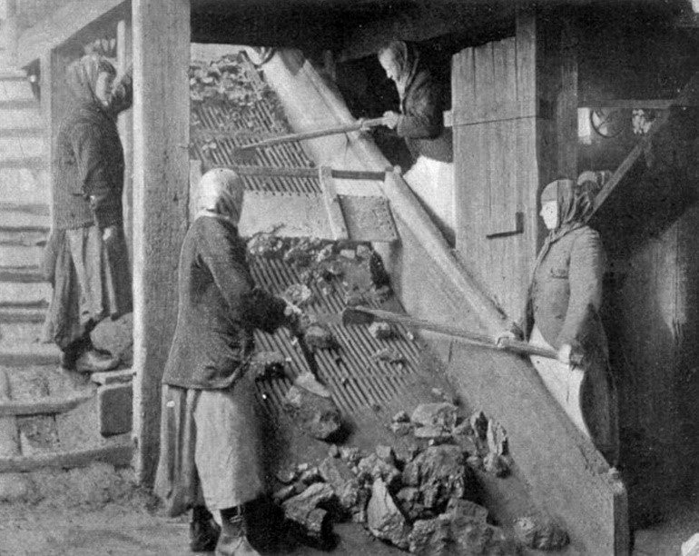 Pit brow women at a conveyor belt sorting coal 