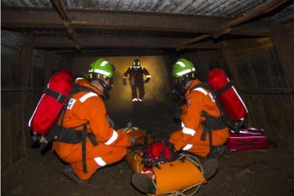 Three men in a confined space completing recovery and rescue training