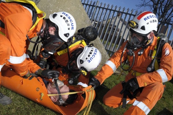 Three men carrying out a confined space rescue course