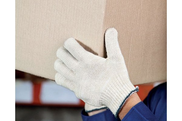 A person with safety gloves carrying a box during manual handling