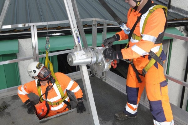 Two men in hi vis gear taking part in the Medium Risk Confined Spaces training course