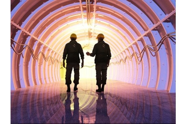 Two men walking into a tunnel