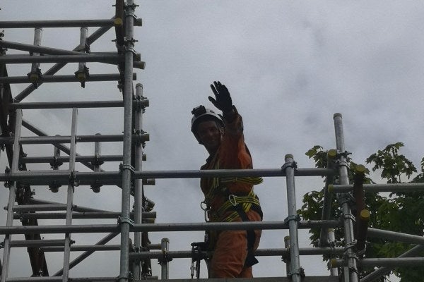 An MRS trainer is at the top of scaffolding, as part of the Rooftop Safety Training Course