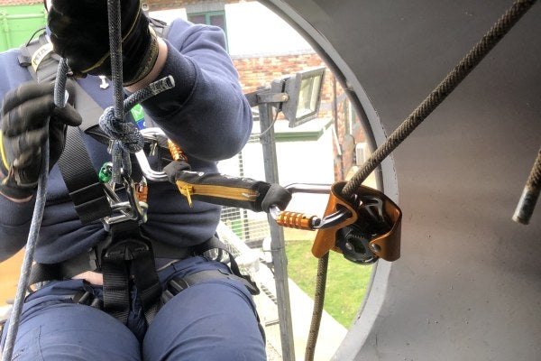 A person is looking closely at a wind turbine during the Working at Height and Rescue training course.