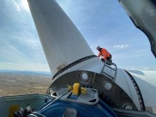 Wind Turbine Technician on the top of a wind turbine 
